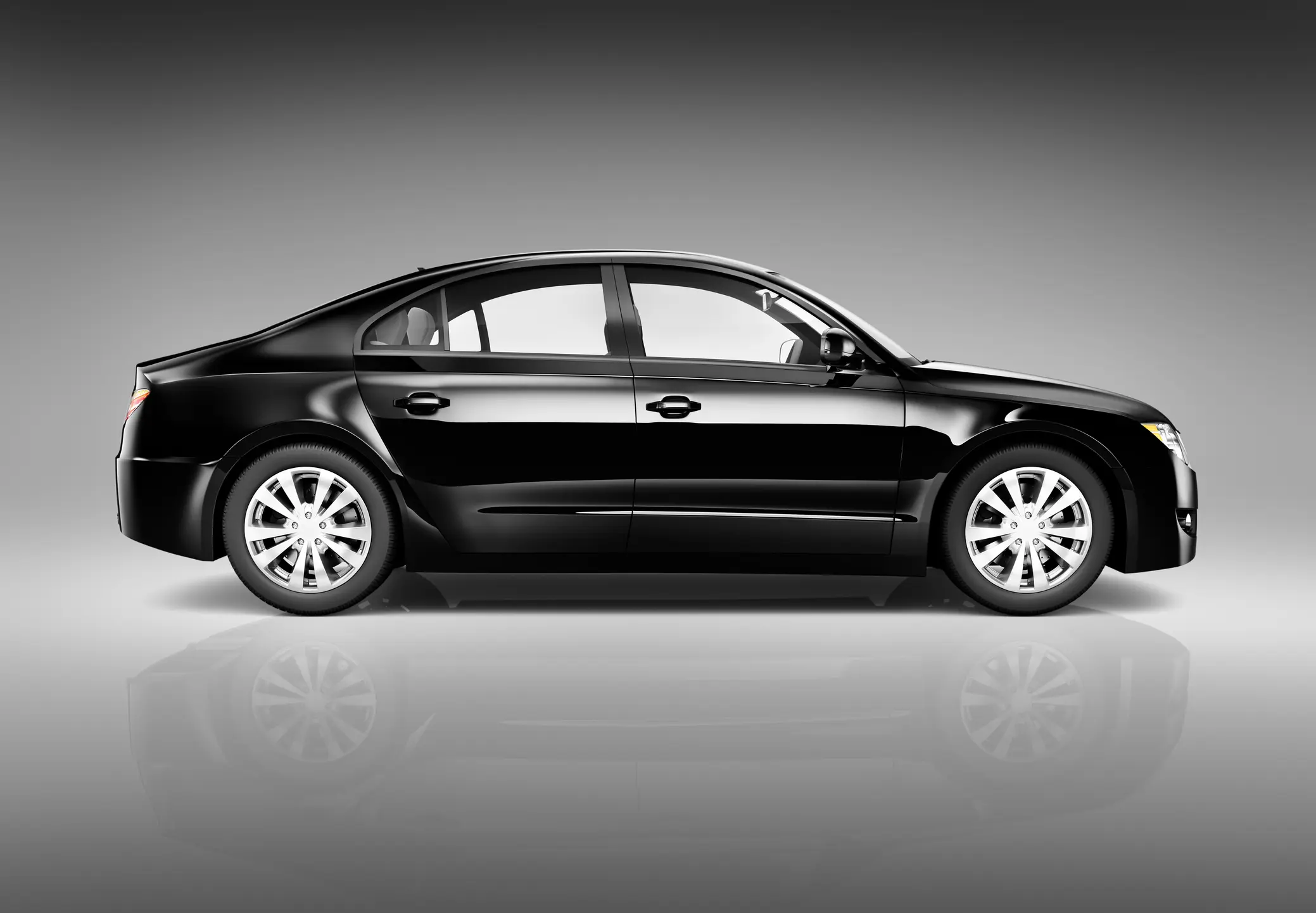 Black sedan car on gray background.